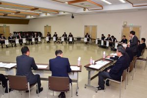 青年部員ら(画面奥)とJA役職員(手前)、立っているのはJAの名倉組合長
